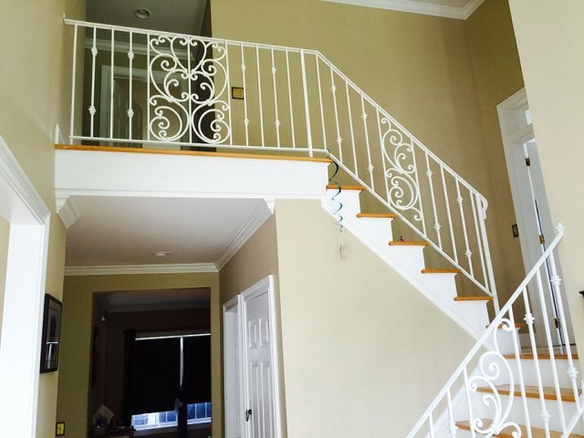 Interior white iron railing going down stairs